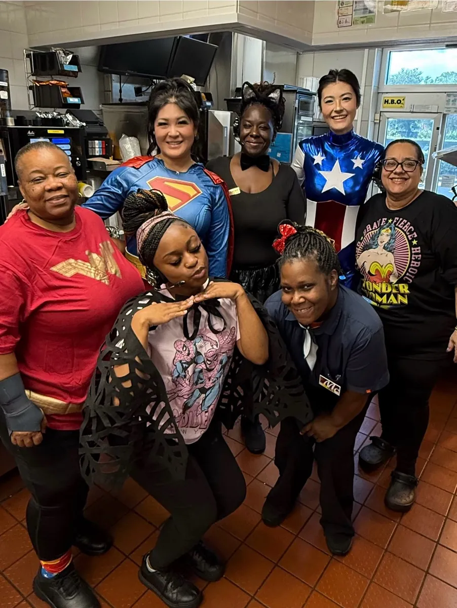 Crew members dressed as superheroes for Superhero Saturday