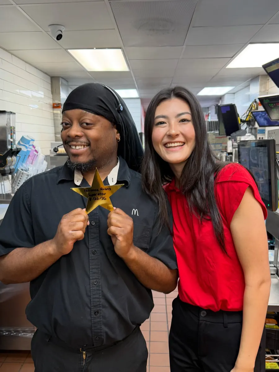 Two crew members holding a gold star for Golden Stars at Store 152