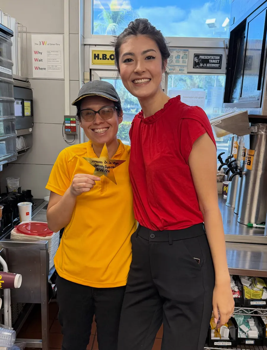 Crew member in yellow with a gold star beside a manager for Golden Stars