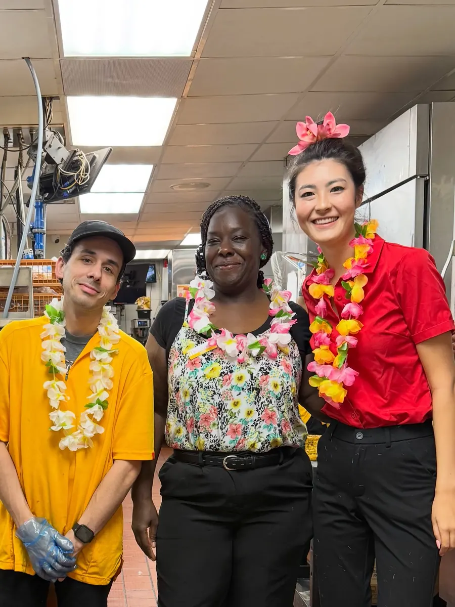 Three crew members in leis and Hawaiian shirts for Maui Monday