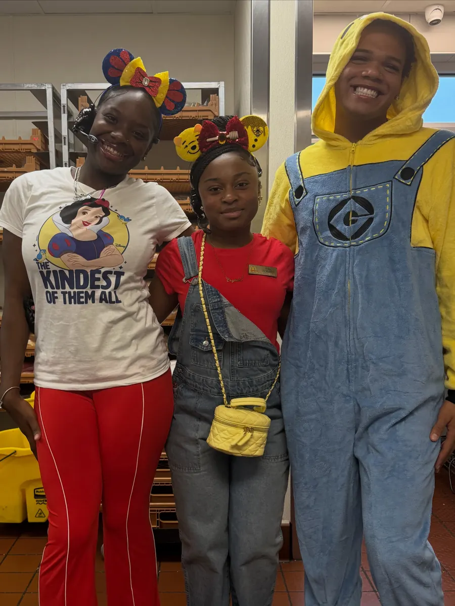 Crew in mouse ears and costumes, including a yellow jumpsuit, for People Week