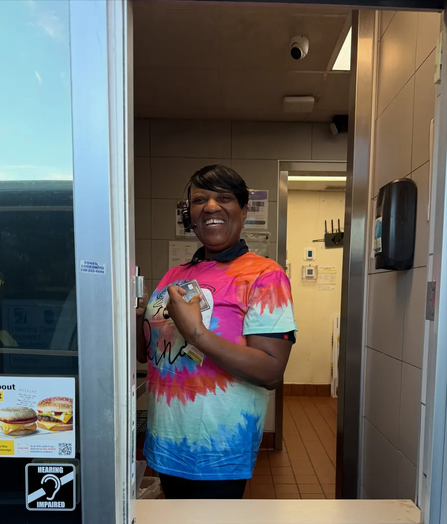 Smiling crew member in a tie-dye shirt for Tie Dye Tuesday