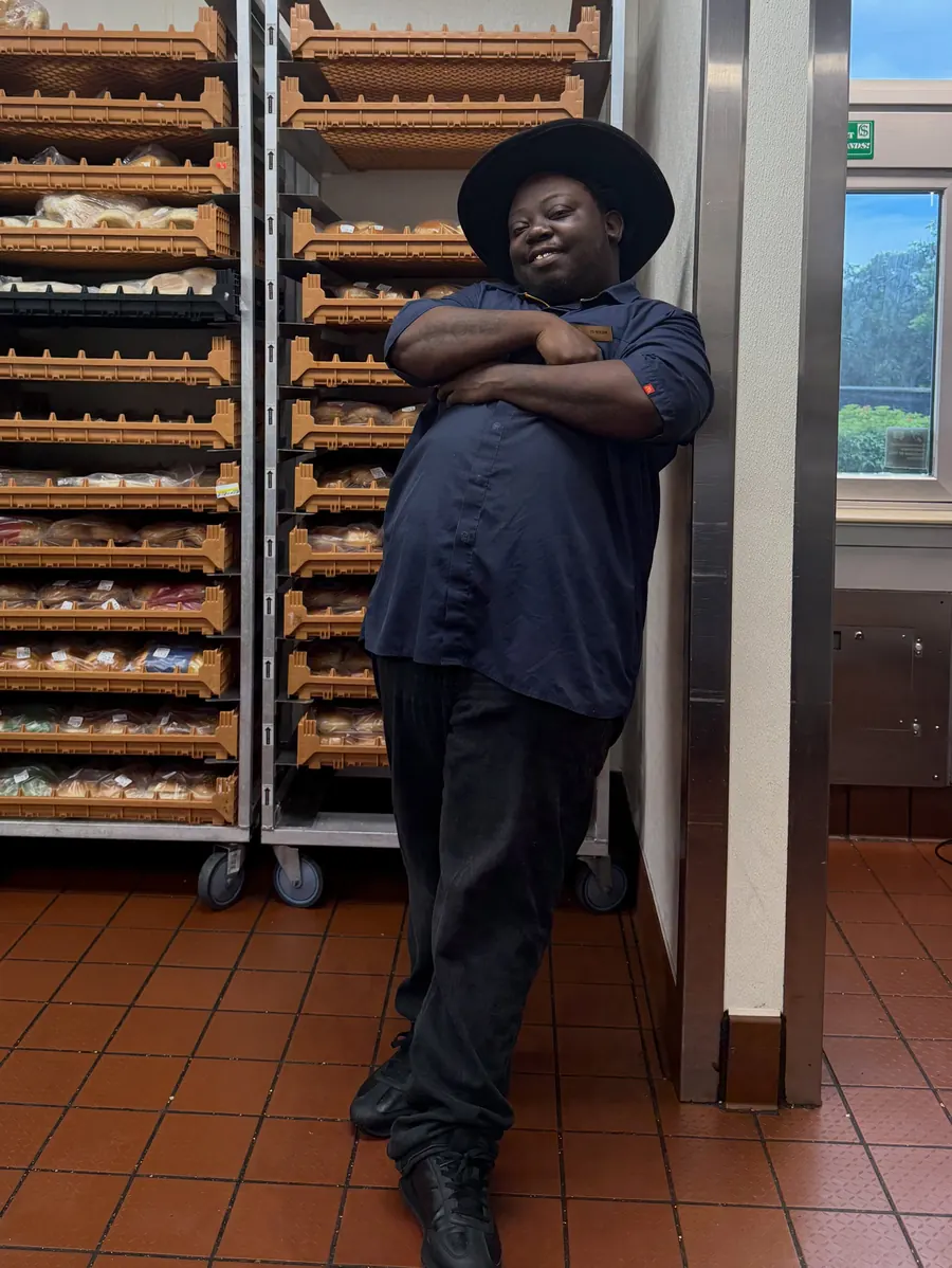 Crew member in a black cowboy hat with arms crossed